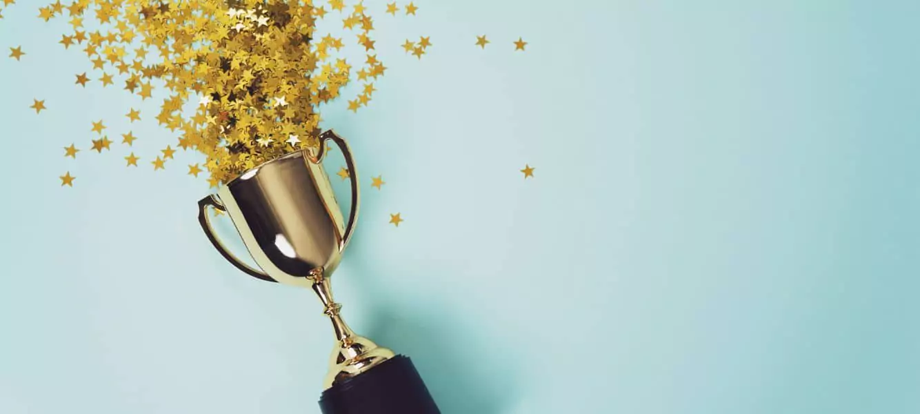 An image of a trophy with confetti pouring out of it on the top employer blog of Astute People's website