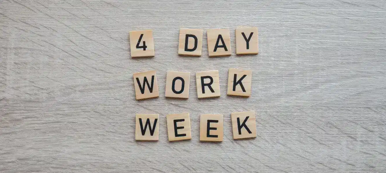 a graphic with tiles that spell out four-day work week on the blog four-day working week