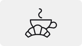 a line drawing of a coffee cup and a croissant