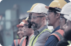 a line of people all wearing safety gear and hard hats