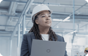 an image of a woman with a white hard hat in a factory