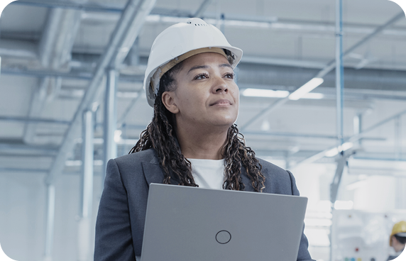 an image of a woman with a white hard hat in a factory