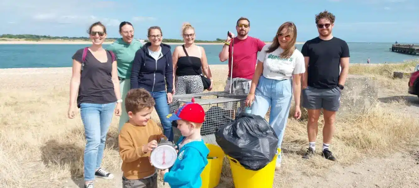 Members of Astute People show their commitment to environmental wellbeing by cleaning a beach