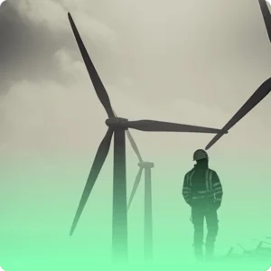 an image of a man stood next to three wind turbines