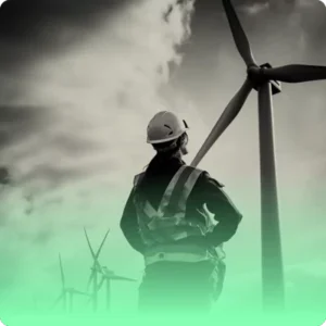 a woman looks at a wind turbine