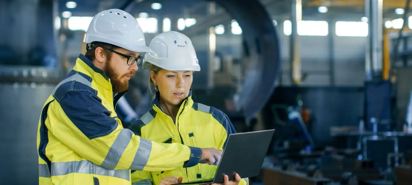 two people at a power station looking at a computer screen for the contractor jobs blog on Astute People's website