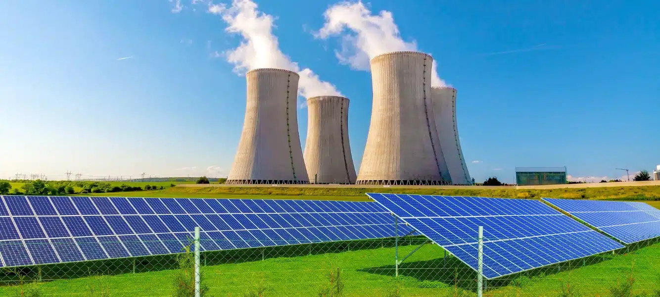 nuclear energy being created by nuclear reactors in a field with solar panels